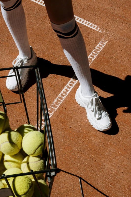 Clean tennis shoes on a tennis court